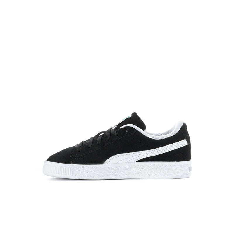 Kids PUMA suede sneakers, black with white stripe and low-profile white sole.
