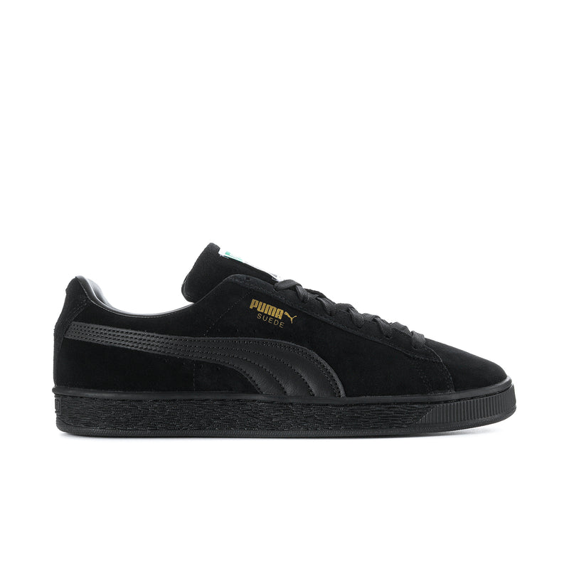Black suede low-top sneakers with lace-up, Puma logo, and textured rubber sole.