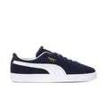 Men's navy suede low-top sneakers with white Puma stripe, laces, and rubber sole