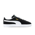 Black suede low-top sneakers with white Puma stripe and black laces