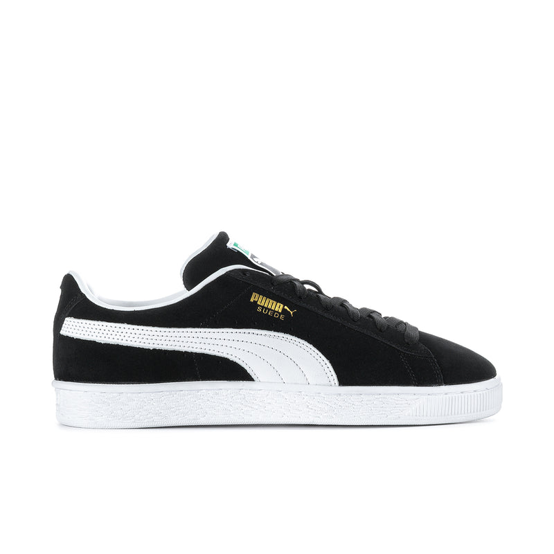 Black suede low-top sneakers with white Puma stripe and black laces