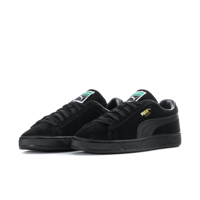 Black suede sneakers, side view with lace-up and Puma branding on tongue.
