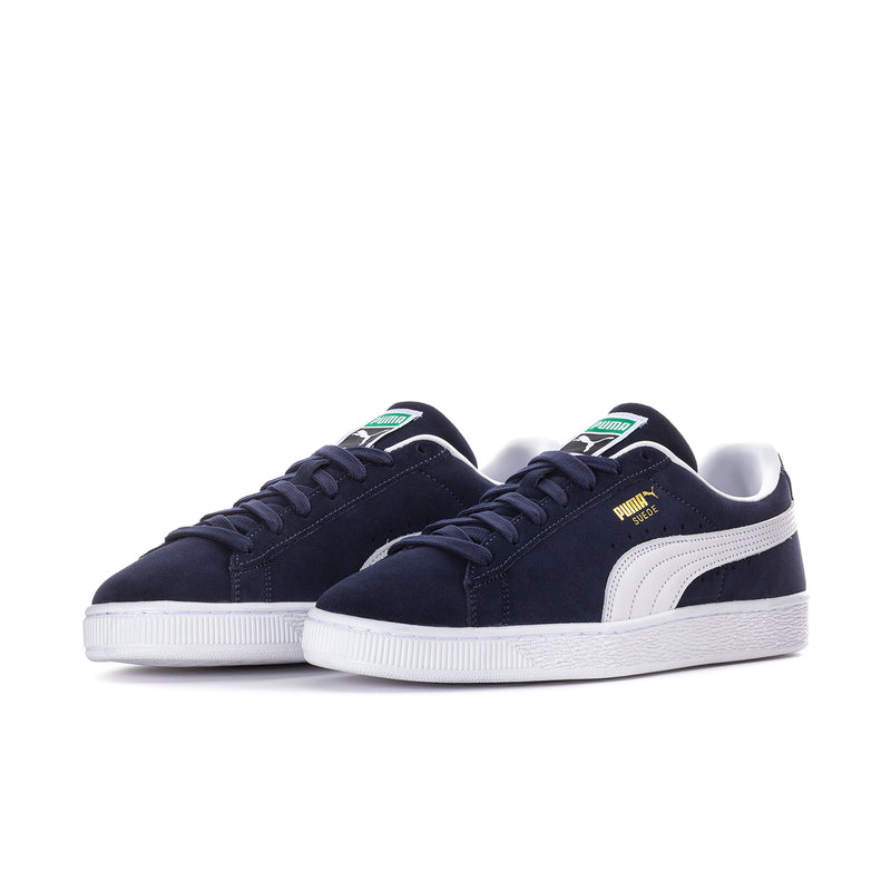 Pair of navy suede low-top sneakers with white Puma stripe and thick white sole