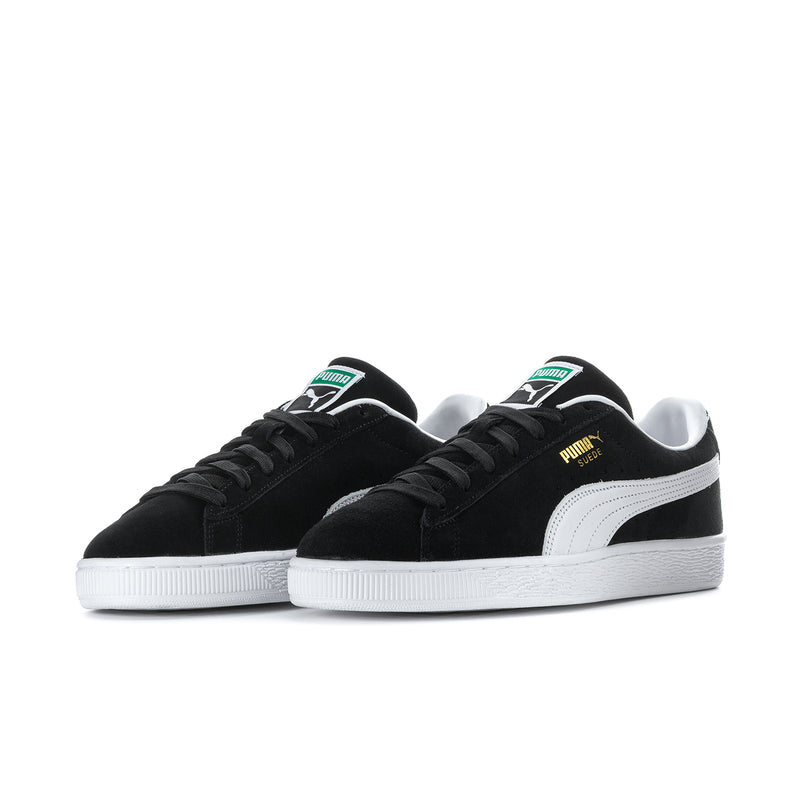 Black suede low-top sneakers, side view, white midsole and Puma logo details