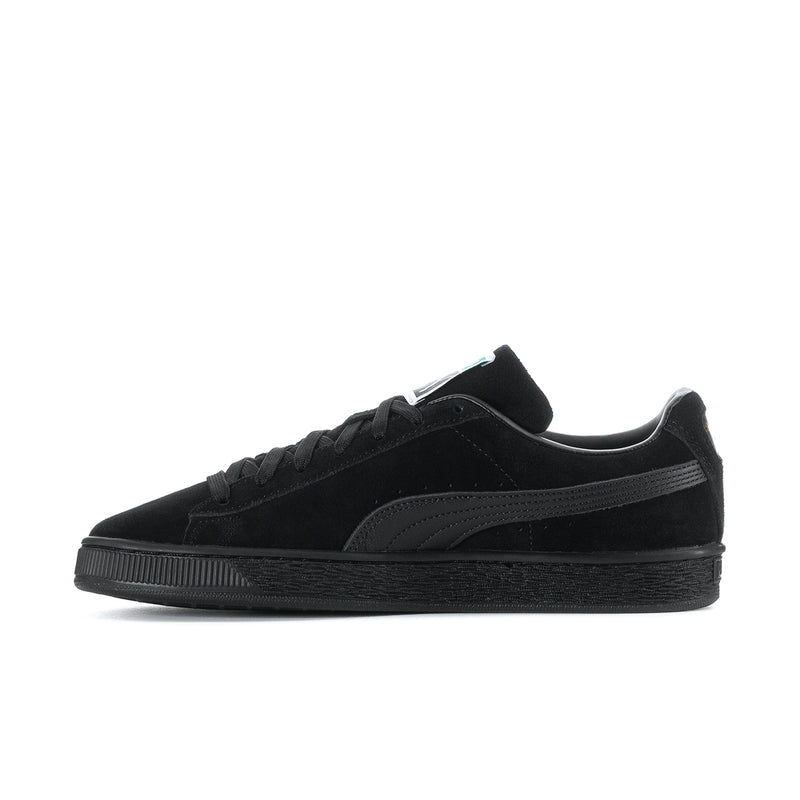 Black suede low-top sneakers side view with lace-up and Puma stripe detail.