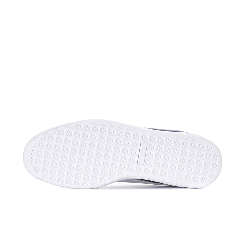 White textured outsole of a navy suede low-top sneaker with Puma mark