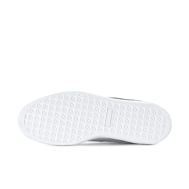 White textured outsole for black suede low-top sneakers with traction pattern