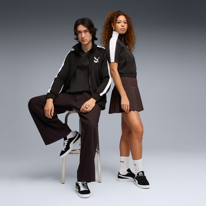 Black suede sneakers worn by models, white Puma stripe and white sole visible