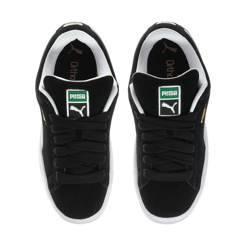 Black suede low-top sneakers with black laces, white lining, and Puma label on tongue
