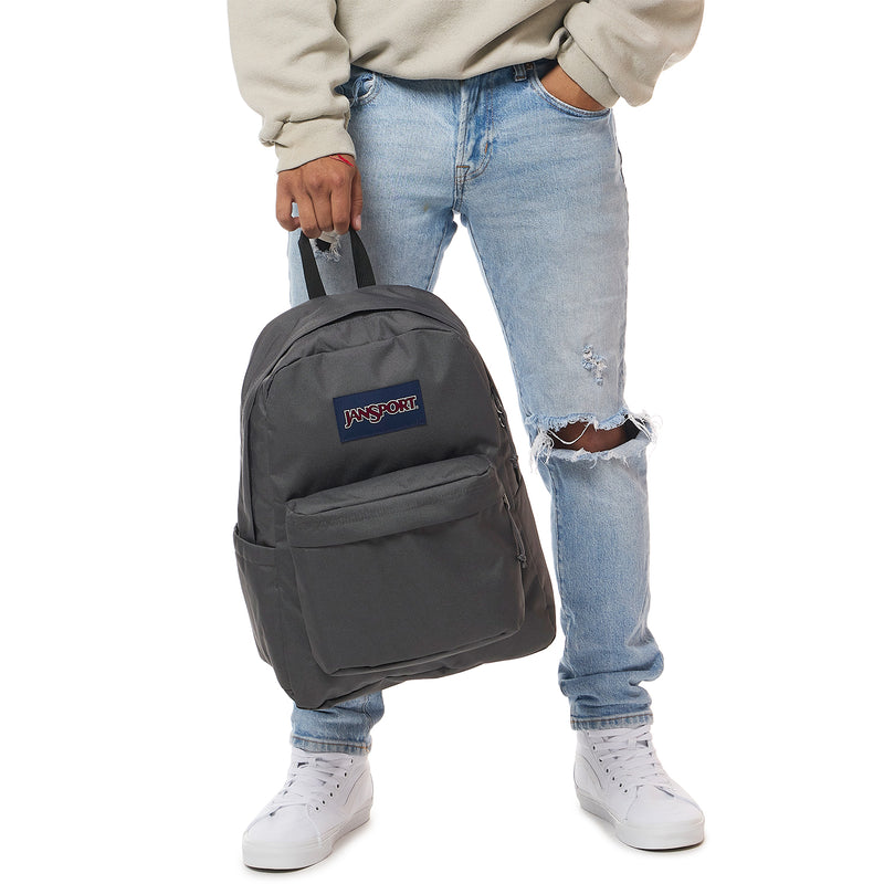 Dark gray Jansport Superbreak Plus backpack worn by a person, front logo visible.