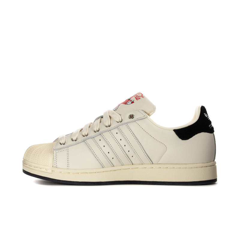 Men's Adidas Superstar II low sneakers, side view with Coca-Cola tongue label and three stripes