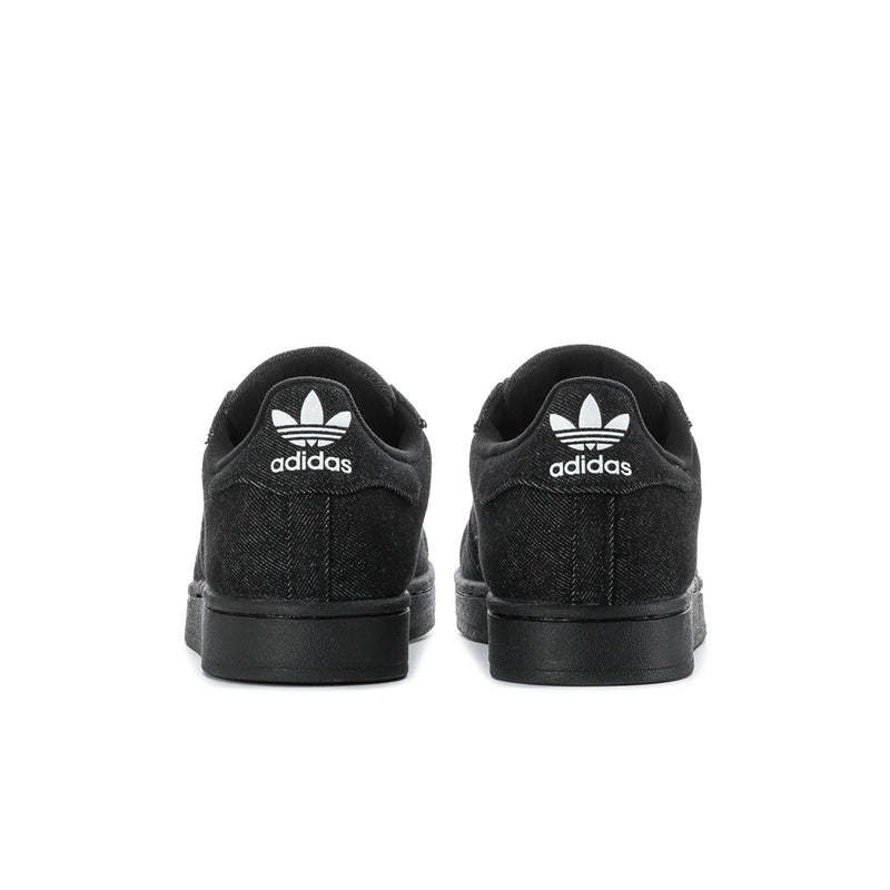 Black low-top sneakers with rear adidas logo and black rubber heel sole