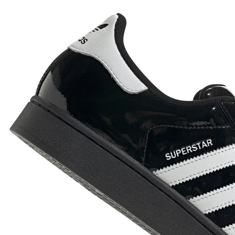 Men's adidas Superstar II sneakers close-up, SUPERSTAR label on black-and-white upper.