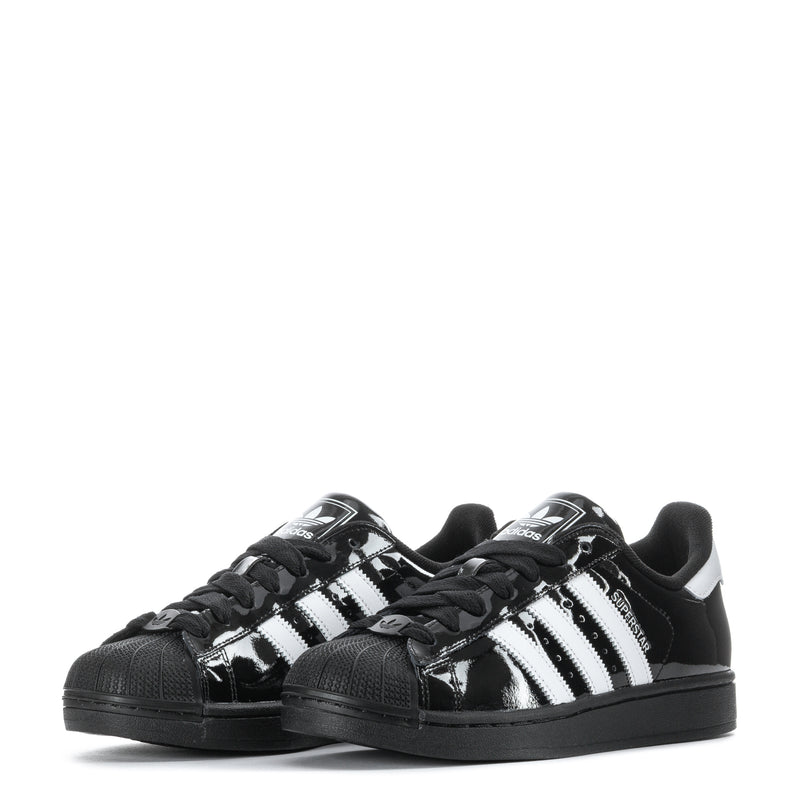Youth low-top sneakers, black gloss with white stripes and textured toe cap