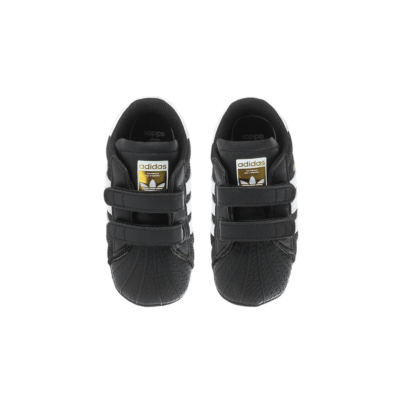 Infant black adidas Superstar sneakers, heel view with adidas logo and straps