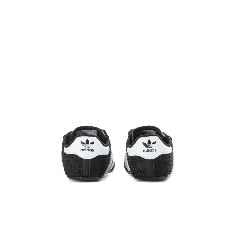 Infant black adidas Superstar sneakers, back view with white adidas trefoil logo