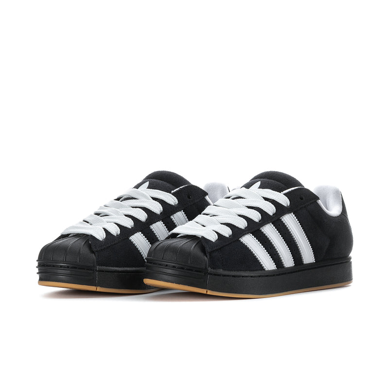 Pair of black and white men's low-top sneakers with three stripes and gum outsole.