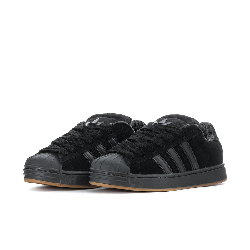 Superstar ST men's sneakers, side view pair, black upper with striped detailing and gum sole