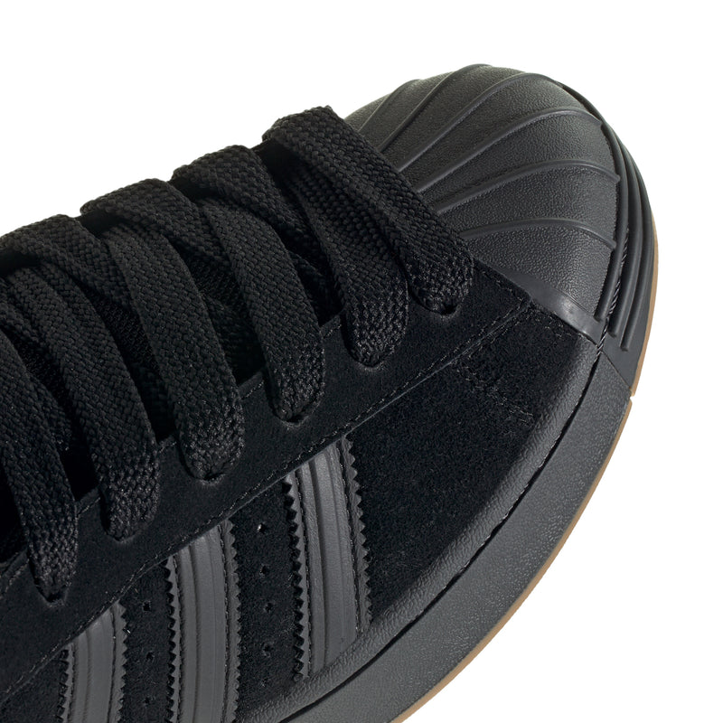 Superstar ST men's sneakers close-up, black laces with three stripe detail on side
