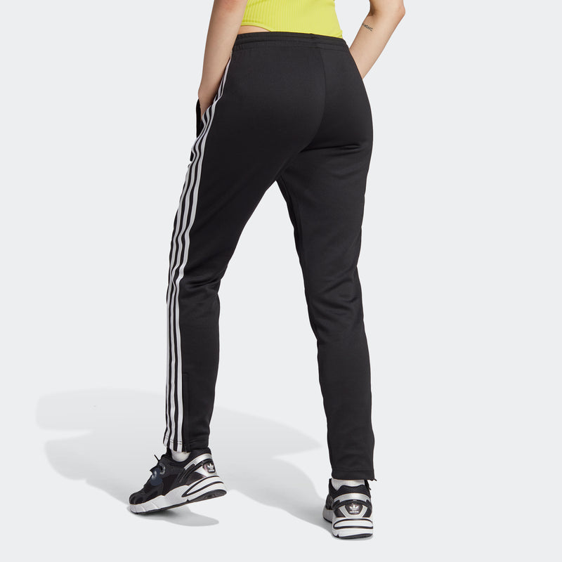 Women's black track pants with white side stripes and tapered ankle-length fit