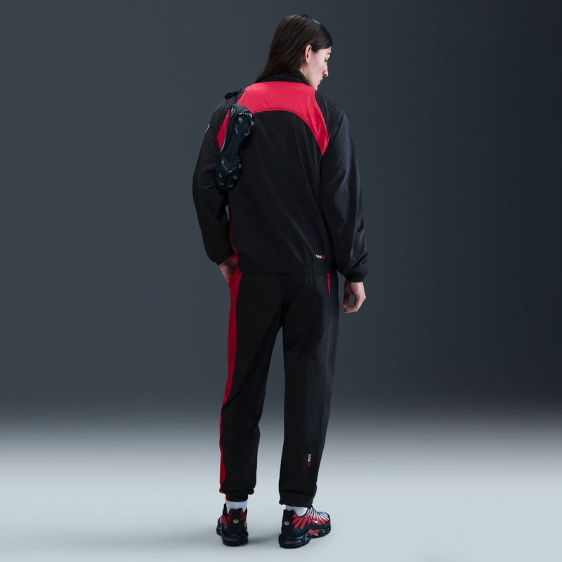 Men's black track pants with red back yoke and side stripe; Nike swoosh