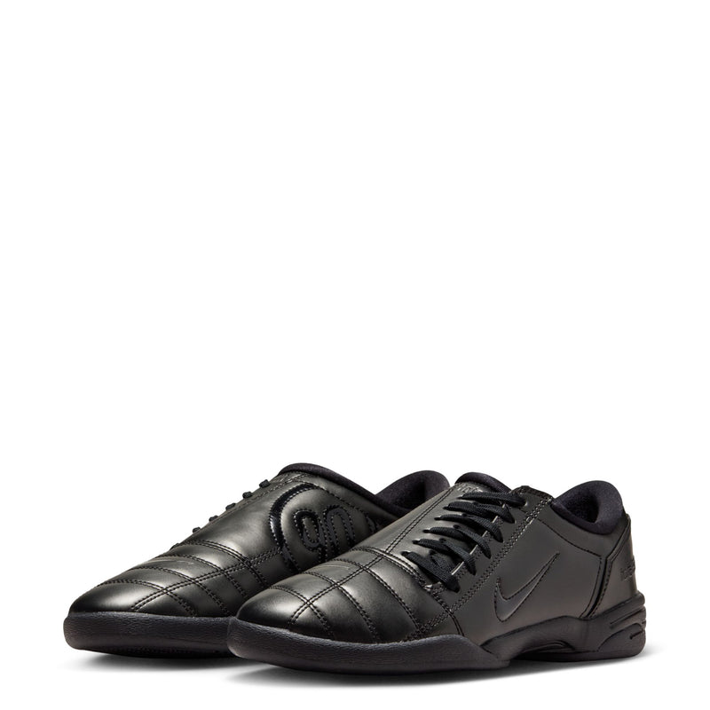 Women's T90 black sneakers, side view with Nike swoosh and lace-up front.