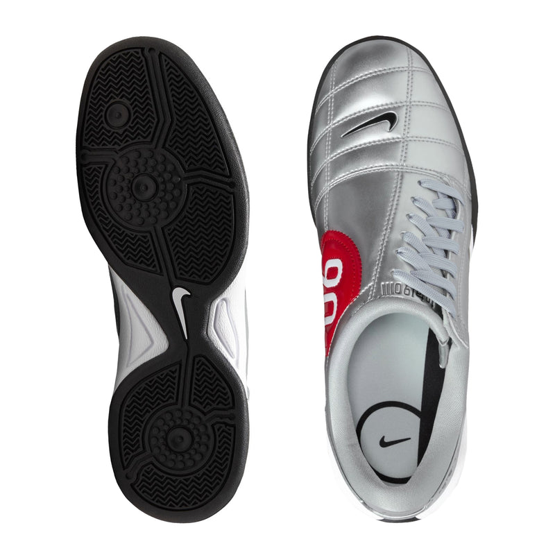 Silver women’s sneaker outsole and side profile with black traction pattern and lace-up