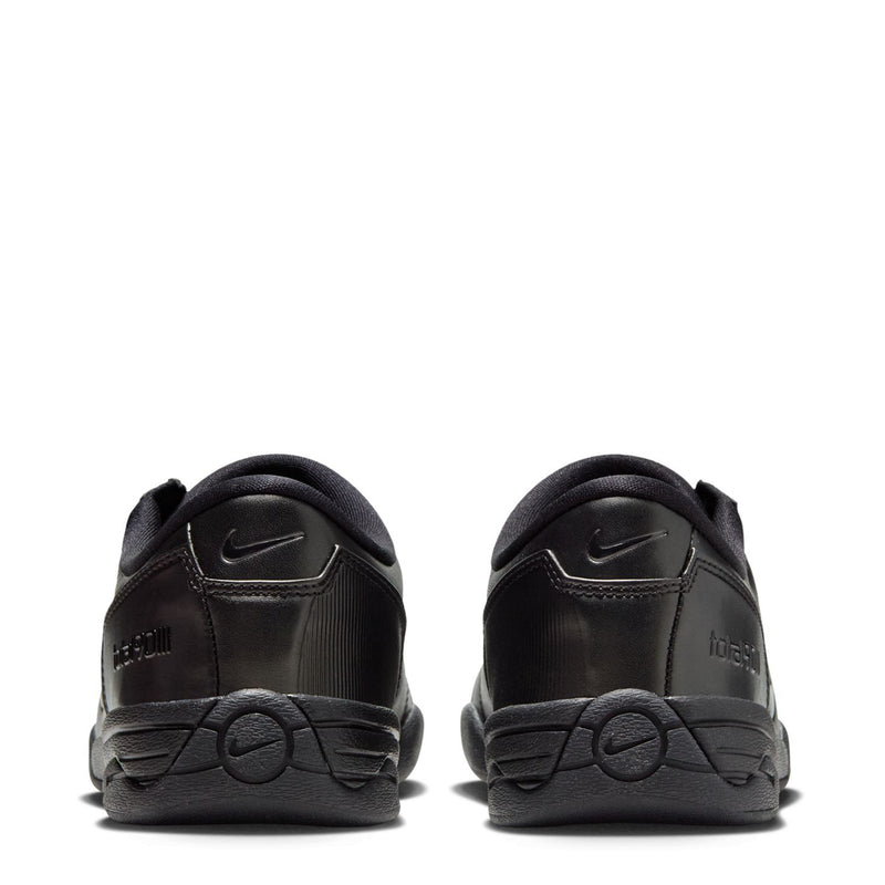 Women's T90 black sneaker back view with Nike swoosh and lace-up collar padding.