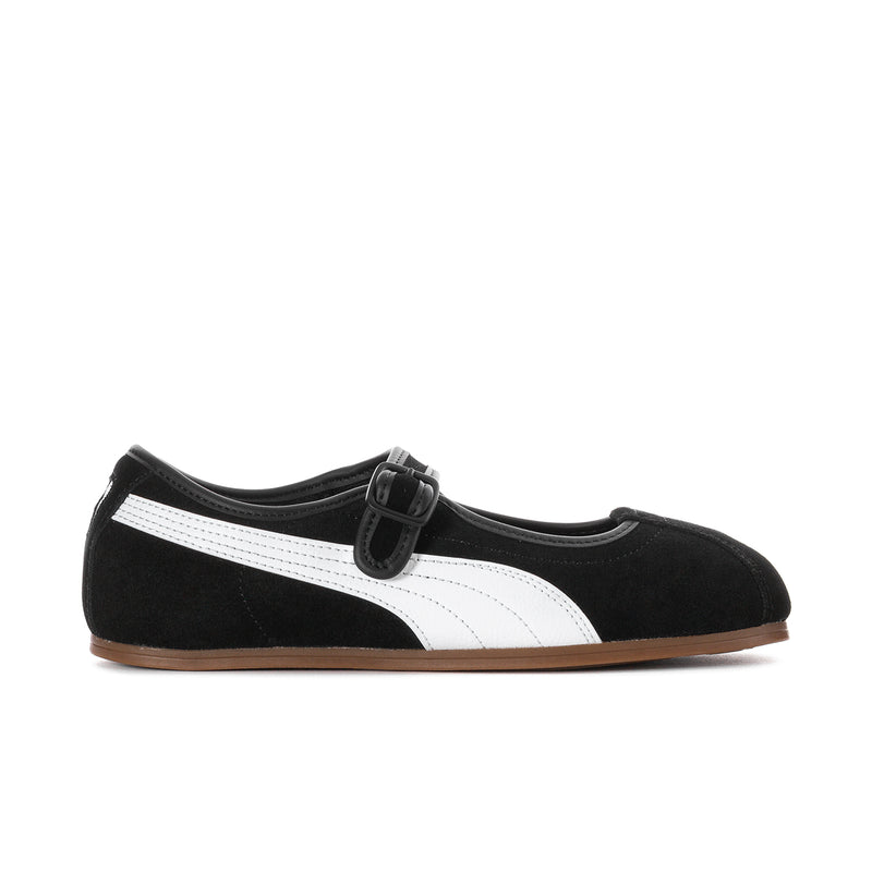 Women's black suede slip-on flats with white stripe, buckle strap, and gum sole.