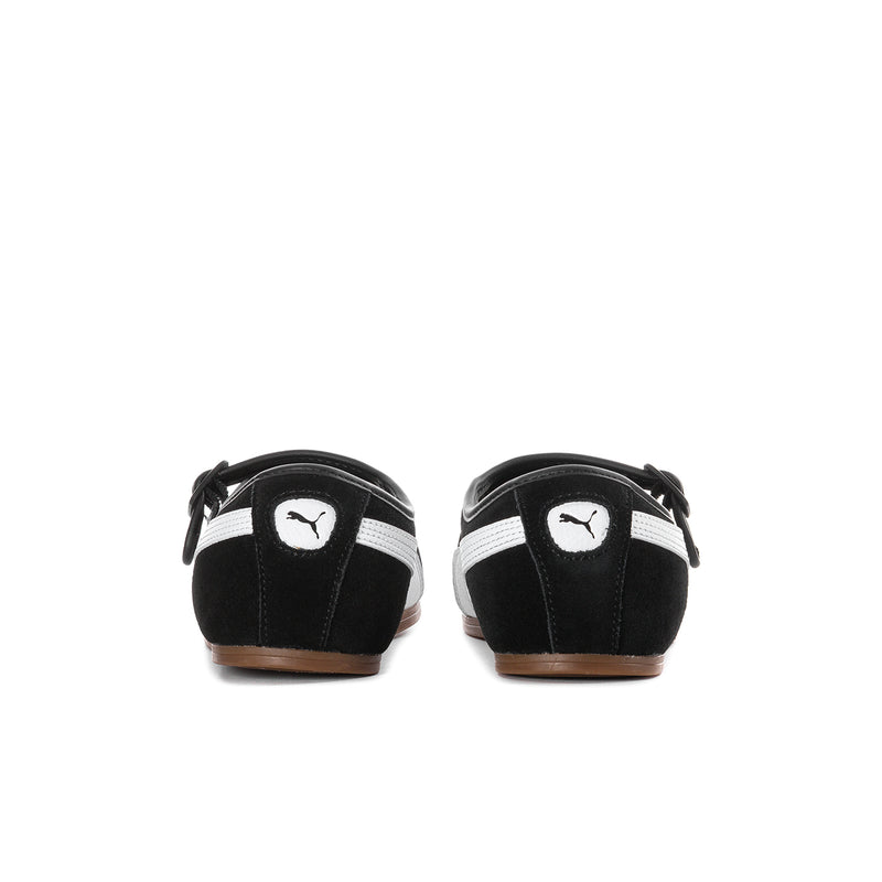 Women's black suede flats with PUMA heel logo, strap detail, and gum outsole.