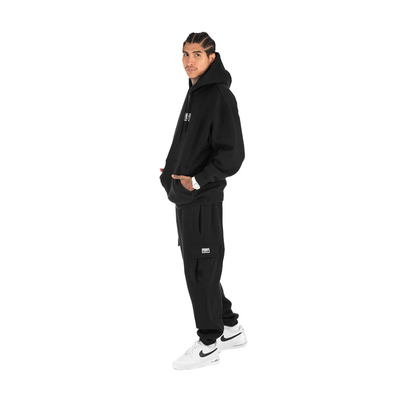 Men's black tapered cargo fleece pants on-model, elastic waist and side pockets