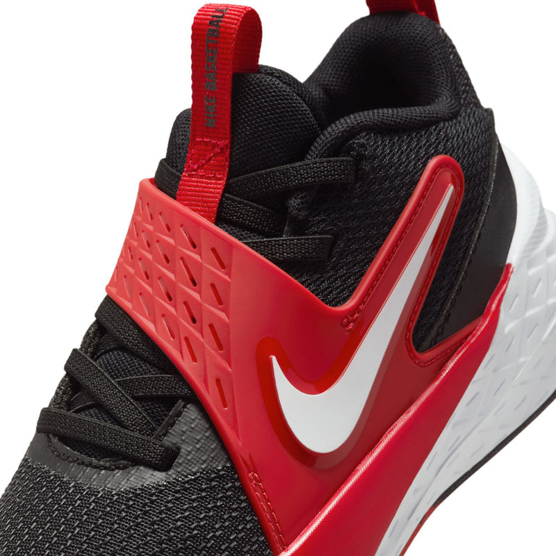 Kids' black and red athletic shoe with white swoosh, red lace strap, and textured sole.