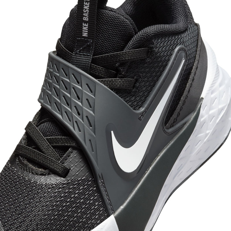 Kids Nike shoe close-up, black mesh upper with gray swoosh and cushioning pods
