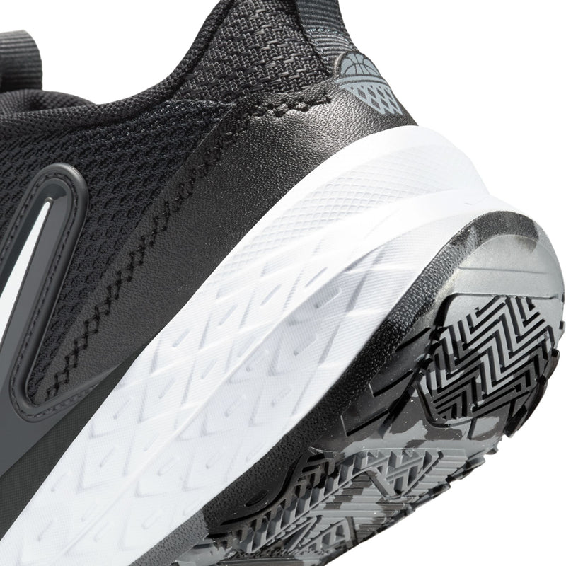Kids Nike shoe outsole close-up with zigzag tread and white cushioning midsole