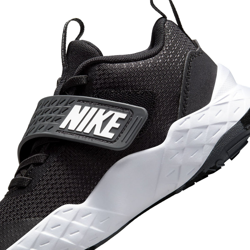 Kids Nike athletic shoe side close-up, black knit with NIKE strap and white sole