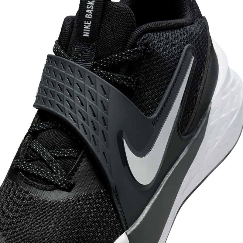 Youth Nike sneaker side close-up, black mesh with gray Swoosh and textured midsole
