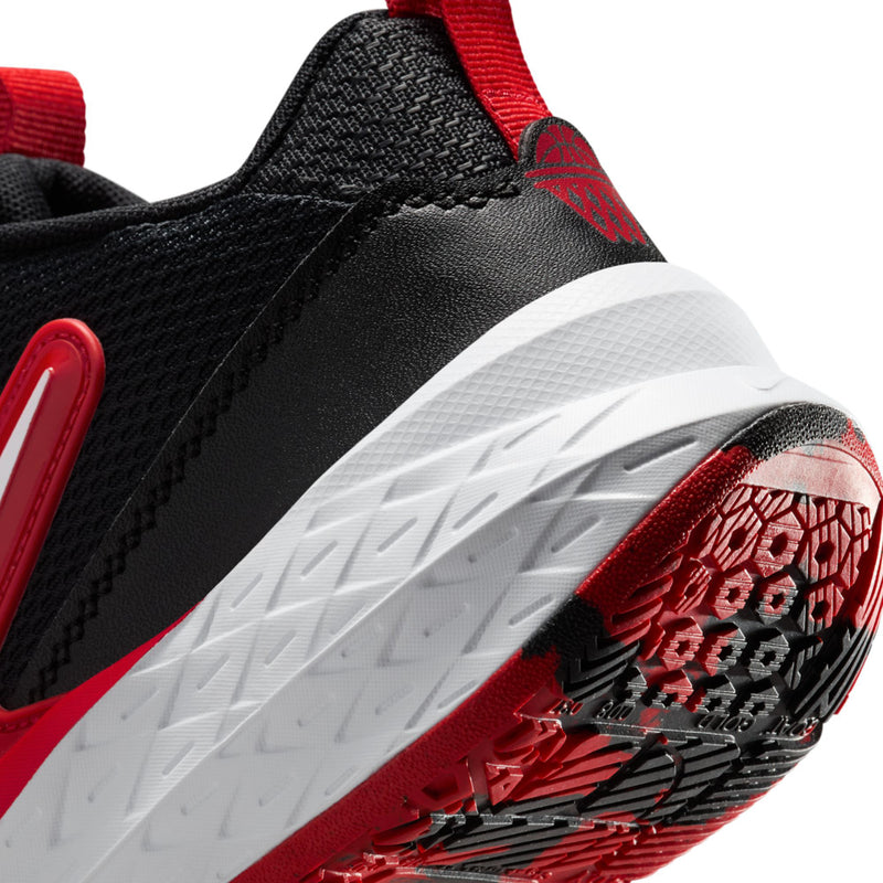 Youth sneaker outsole close-up, white midsole edge with red traction lugs