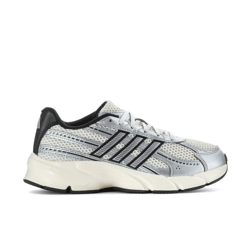 Women’s running shoes in chalk white and silver with black accents, lace-up
