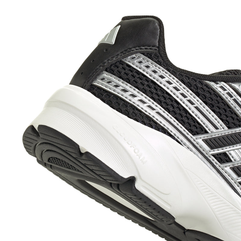 Black and silver sneaker side view with textured tread sole and metallic stripe upper