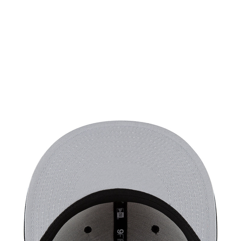 White baseball cap close-up with textured crown and black inner band