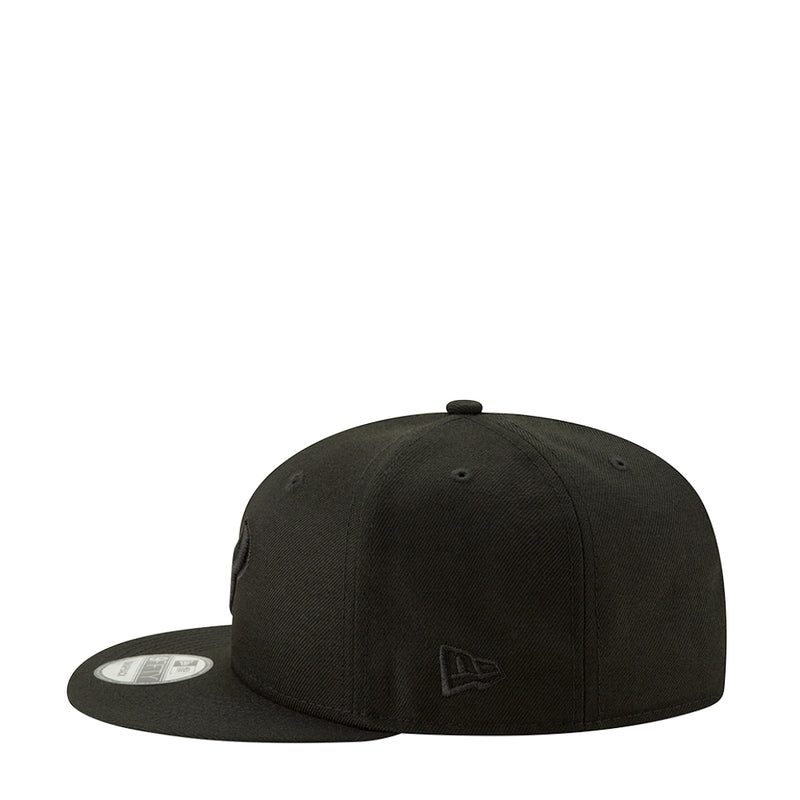 Black baseball cap with small front New Era-style emblem and curved brim