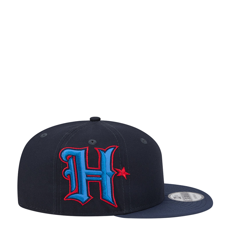 Navy baseball cap with stitched 'H' logo in red and blue on front panel