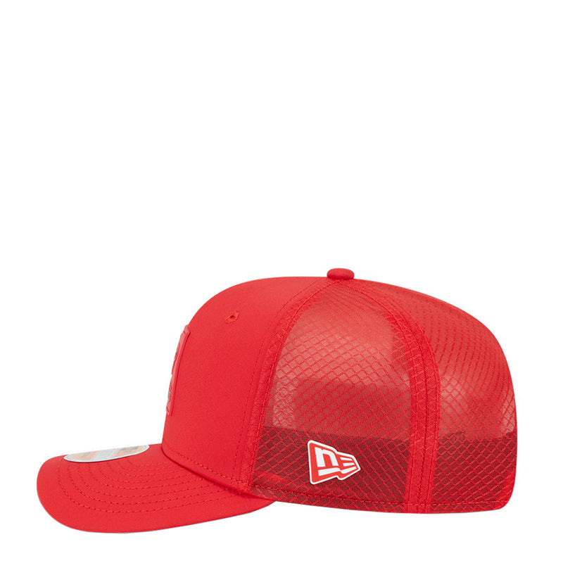 Red cap with mesh crown, New Era logo patch, and curved brim