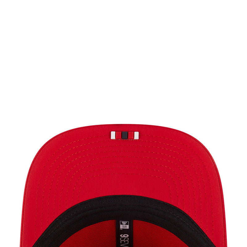 Red cap top with black adjustable strap and ventilation holes