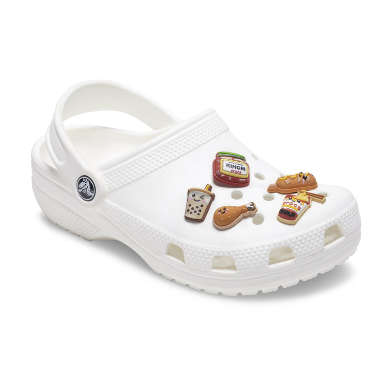White clog with five snack-shaped Jibbitz charms attached