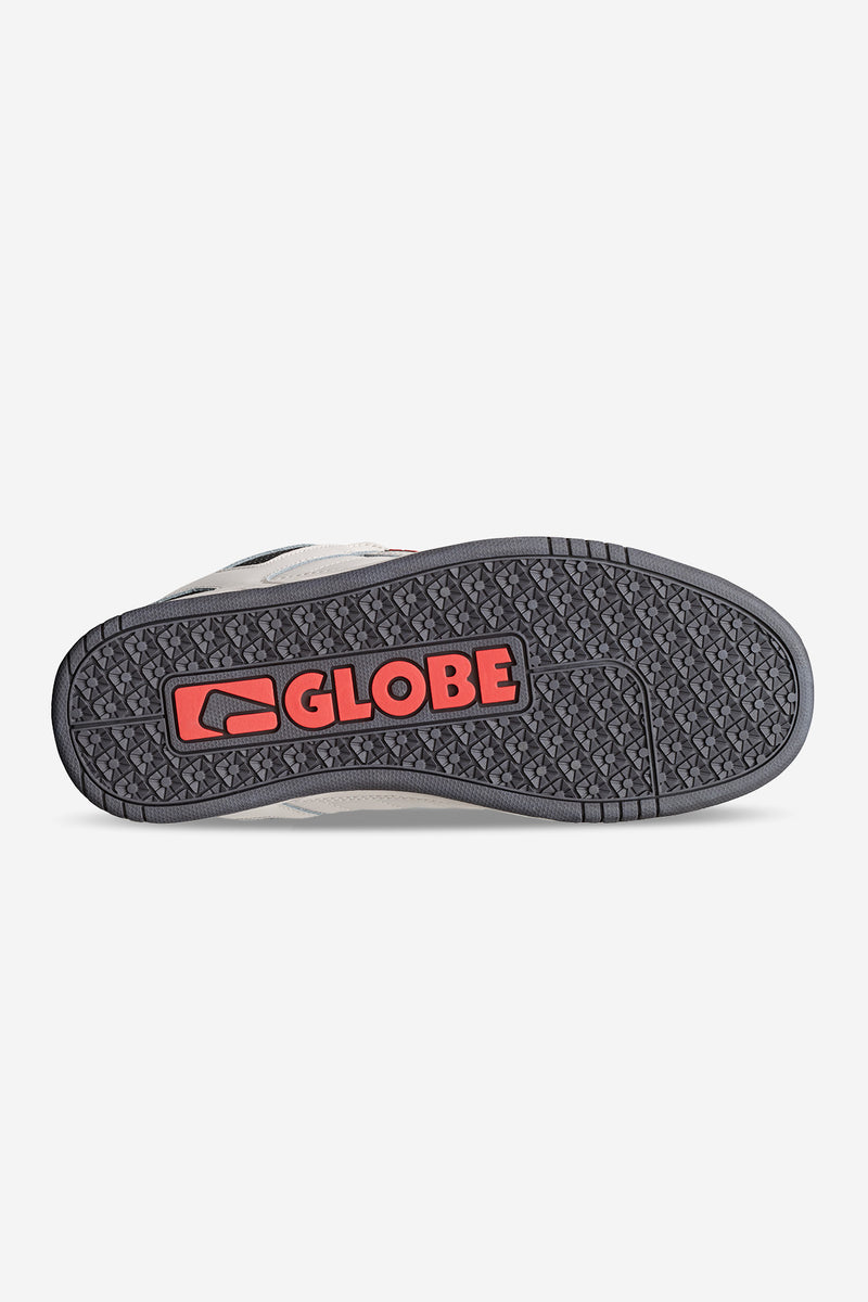 Bottom view of white Tilt Prime shoe showing a textured gray outsole with a red Globe logo