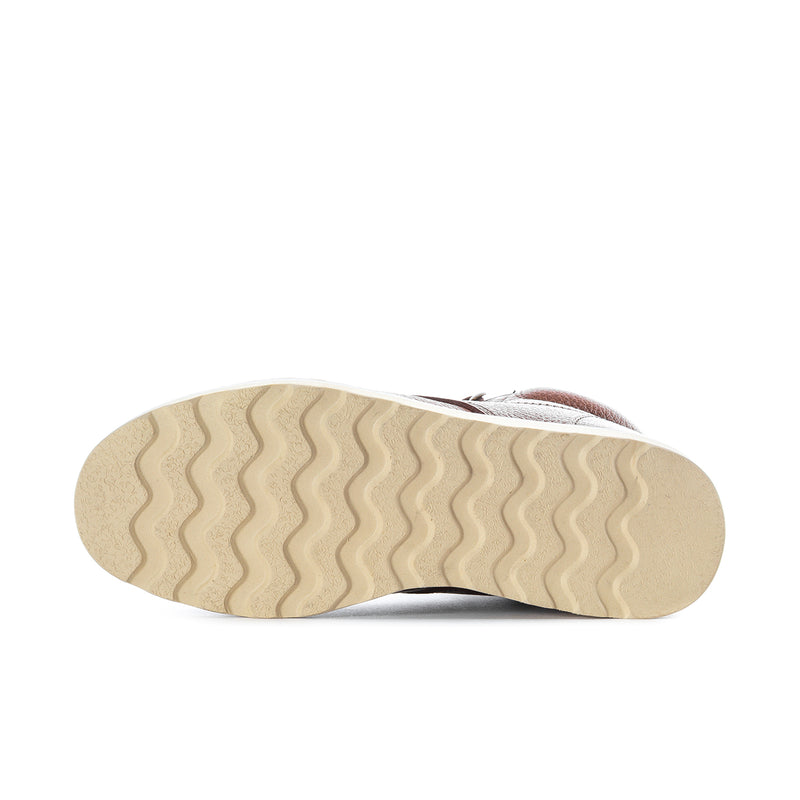 Men's tan boot outsole with wavy tread pattern
