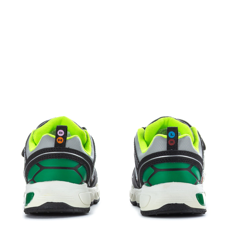 Toddler black sneakers with neon green heel, blue TMNT tag, and back view