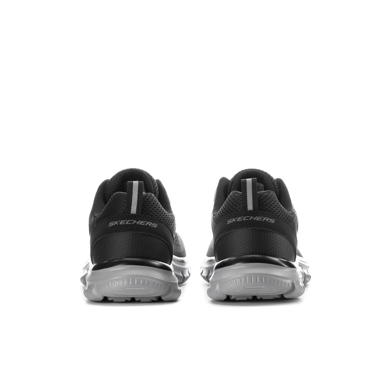 Men's wide black lace-up sneakers with SKECHERS heel branding and chunky gray sole