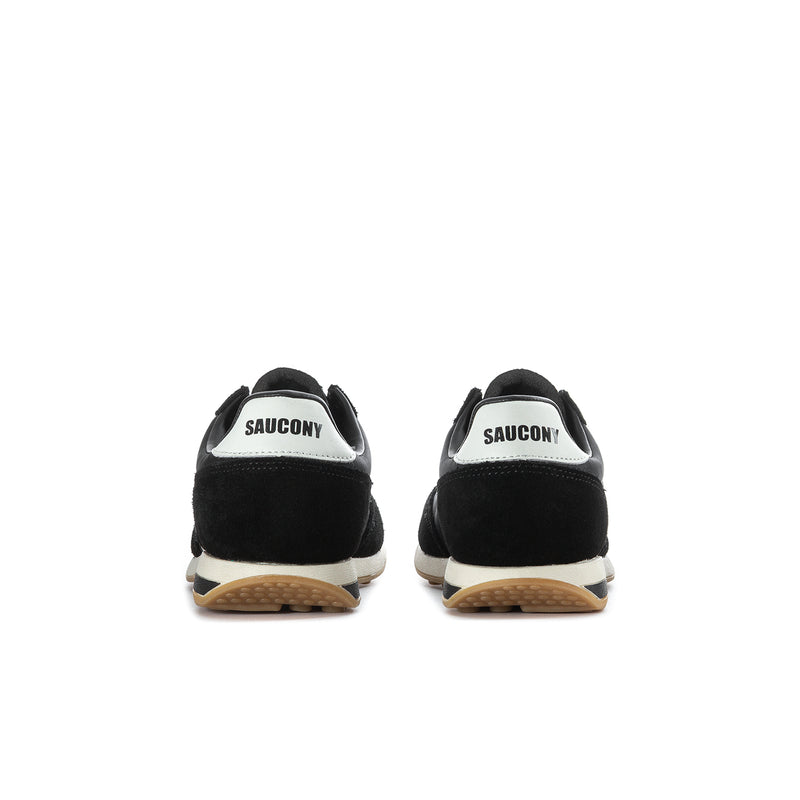 Youth black sneaker back view with white heel label and gum sole